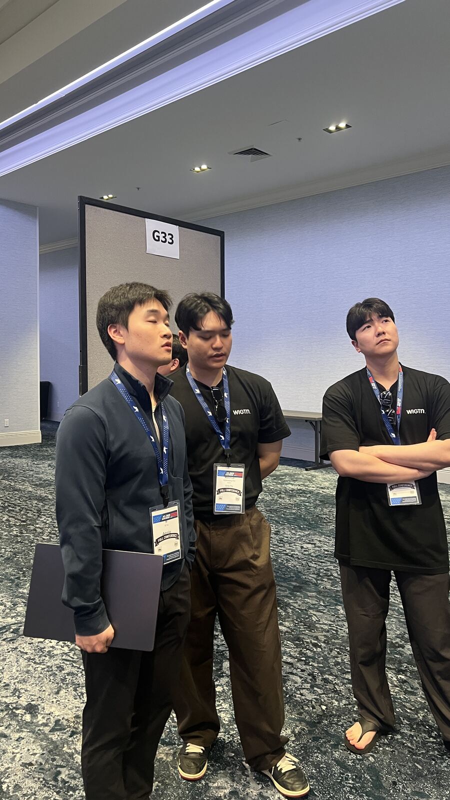 An engineer from Apple looking at the WIGVO poster with a WIGTN team member.