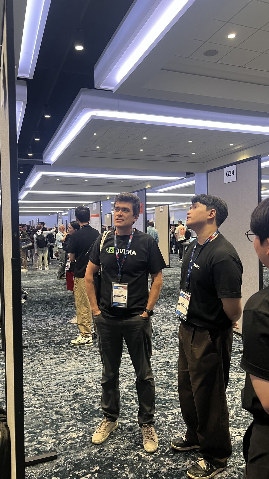 An engineer from NVIDIA in conversation with the WIGTN team at the poster boards.