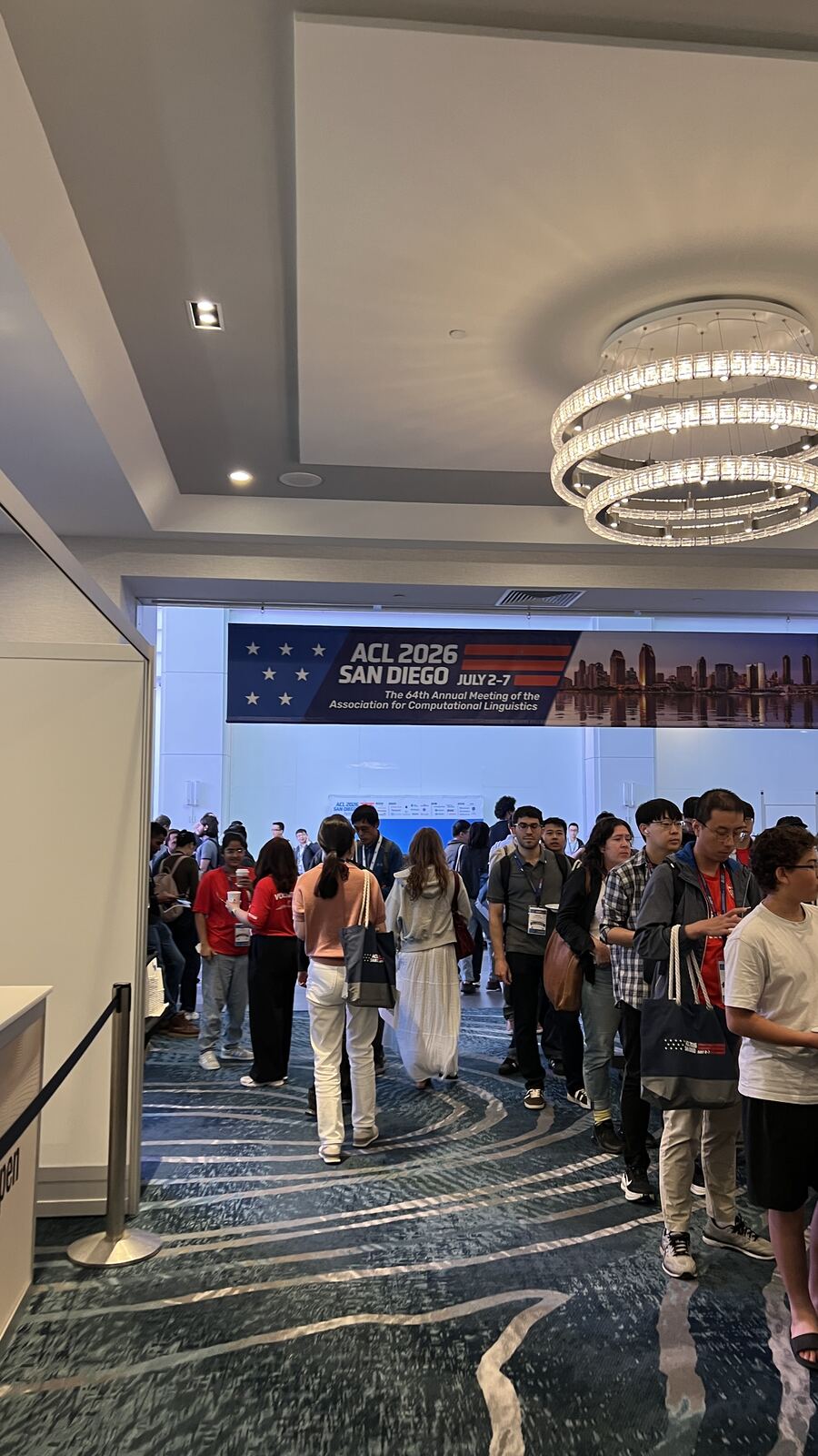 Attendees filing through the hallway under the ACL 2026 San Diego banner between sessions.